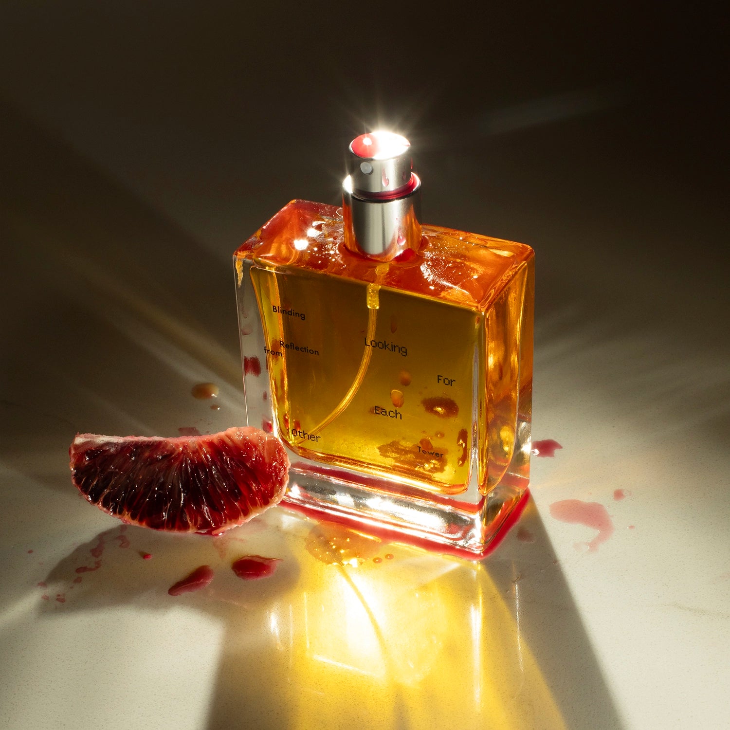 50ml bottle of Blinding Reflection from Tower Window natural perfume next to a blood orange segment, highlighting its citrus-forward botanical formula.