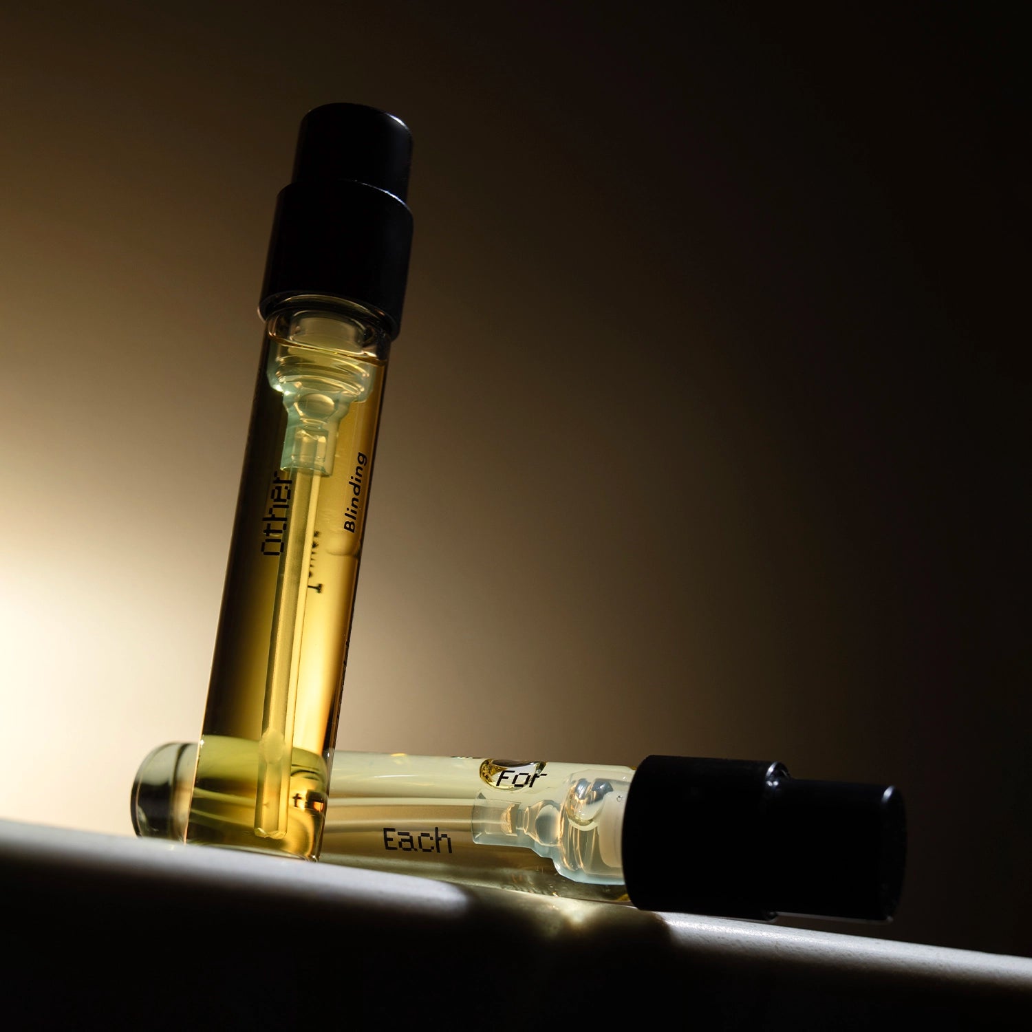 Discovery Duo 2ml natural perfume samples – genderless botanical scents by Looking for Each Other in amber-tinted light.