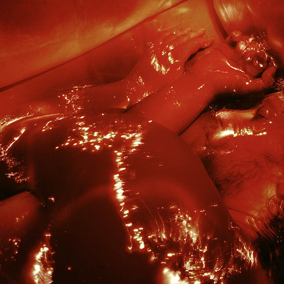 Red-lit image of a body drenched in glossy, glowing light—visceral and alive. Represents the bold, sensual heat of the Flare scent mood from Looking for Each Other.