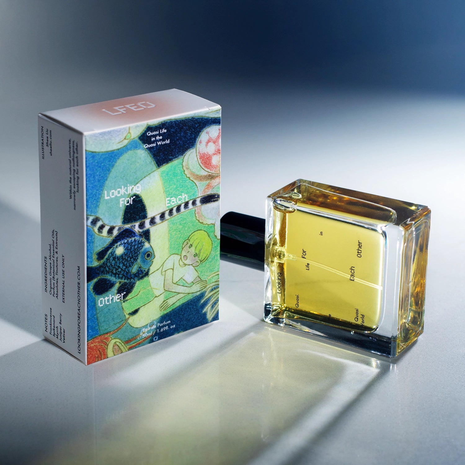 Quasi Life in the Quasi World perfume by Looking For Each Other – a golden botanical fragrance in a rectangular glass bottle lying beside its illustrated box featuring surreal aquatic artwork by Shee Liu of a boy and fish, photographed on a reflective surface with a soft gradient background.