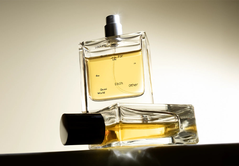 Quasi Life in the Quasi World by Looking for Each Other — clean, synthetic-free fragrance in glass bottles glowing under soft golden light.